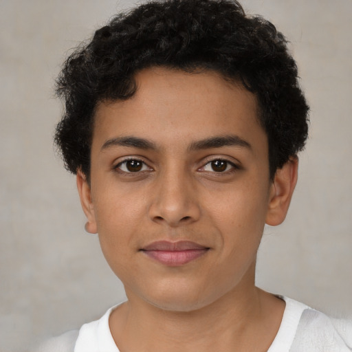 Joyful latino young-adult male with short  brown hair and brown eyes