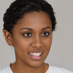 Joyful black young-adult female with short  brown hair and brown eyes