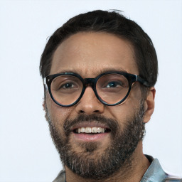 Joyful black young-adult male with short  black hair and brown eyes