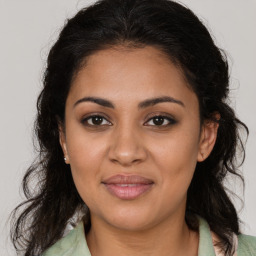 Joyful latino young-adult female with medium  brown hair and brown eyes