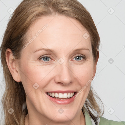 Joyful white young-adult female with medium  brown hair and blue eyes