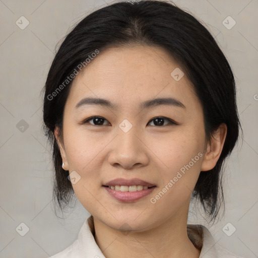 Joyful asian young-adult female with medium  black hair and brown eyes