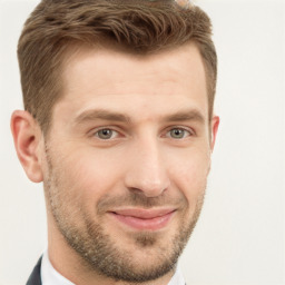 Joyful white young-adult male with short  brown hair and grey eyes