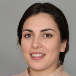 Joyful white young-adult female with medium  brown hair and brown eyes