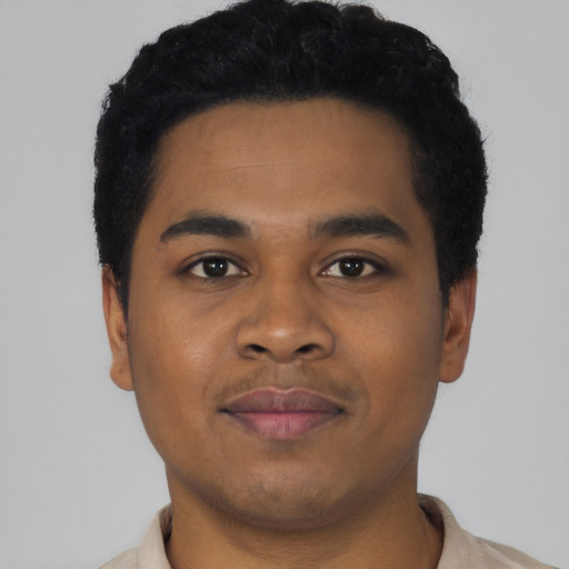 Joyful black young-adult male with short  black hair and brown eyes