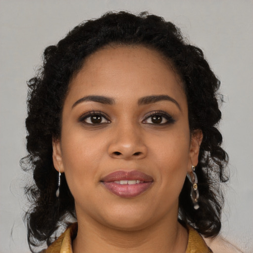Joyful black young-adult female with long  brown hair and brown eyes