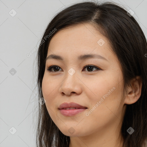 Joyful asian young-adult female with long  brown hair and brown eyes