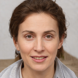 Joyful white adult female with short  brown hair and brown eyes