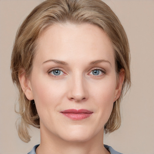 Joyful white young-adult female with medium  brown hair and blue eyes