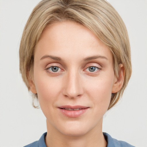 Joyful white young-adult female with medium  brown hair and blue eyes