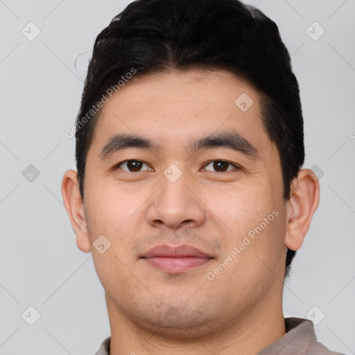 Joyful asian young-adult male with short  brown hair and brown eyes