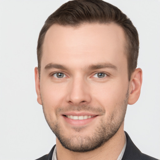 Joyful white young-adult male with short  brown hair and brown eyes