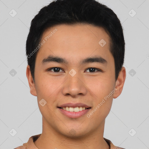 Joyful asian young-adult male with short  brown hair and brown eyes