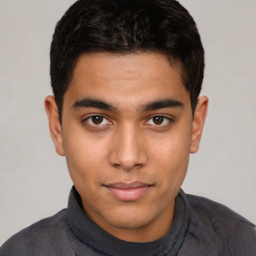 Joyful latino young-adult male with short  brown hair and brown eyes