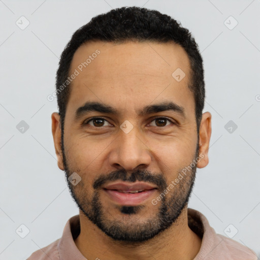 Joyful latino young-adult male with short  black hair and brown eyes