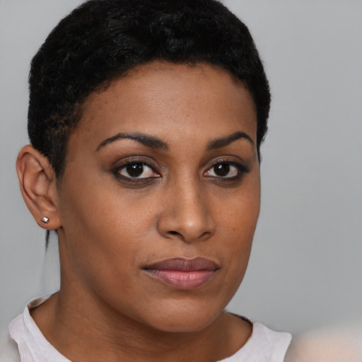 Joyful black young-adult female with short  brown hair and brown eyes