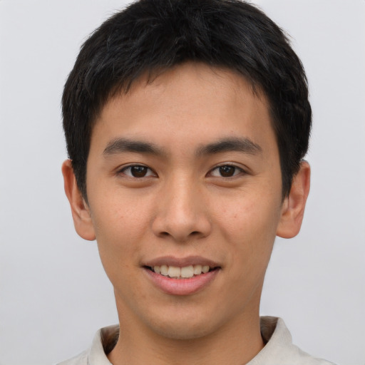 Joyful asian young-adult male with short  brown hair and brown eyes