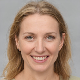 Joyful white adult female with medium  brown hair and grey eyes