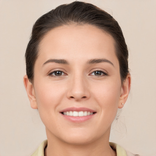 Joyful white young-adult female with short  brown hair and brown eyes