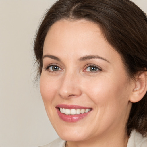 Joyful white adult female with medium  brown hair and brown eyes