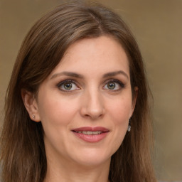 Joyful white young-adult female with long  brown hair and green eyes