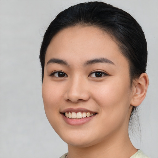 Joyful white young-adult female with medium  black hair and brown eyes
