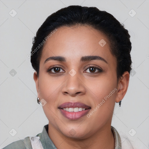 Joyful latino young-adult female with short  black hair and brown eyes