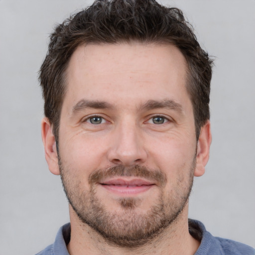 Joyful white adult male with short  brown hair and brown eyes