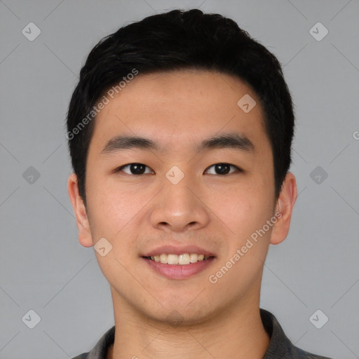 Joyful asian young-adult male with short  black hair and brown eyes