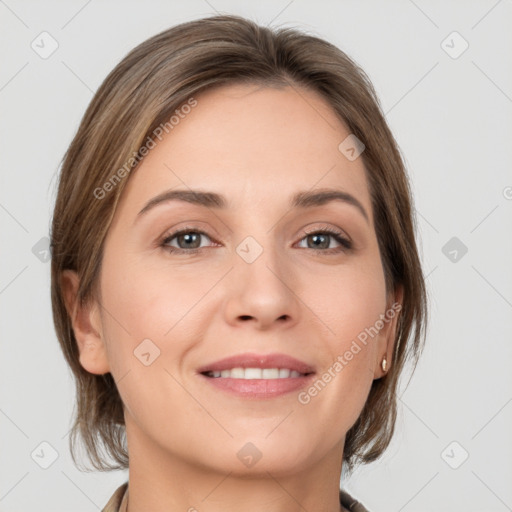 Joyful white young-adult female with medium  brown hair and grey eyes