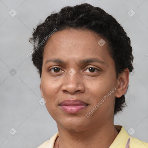 Joyful black adult female with short  black hair and brown eyes