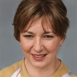 Joyful white adult female with medium  brown hair and brown eyes