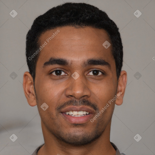 Joyful black young-adult male with short  black hair and brown eyes