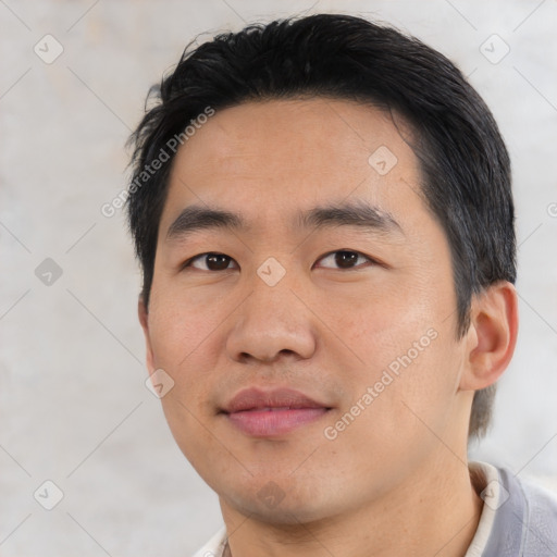 Joyful asian young-adult male with short  black hair and brown eyes