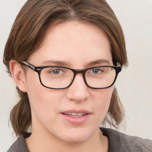 Joyful white young-adult female with medium  brown hair and blue eyes