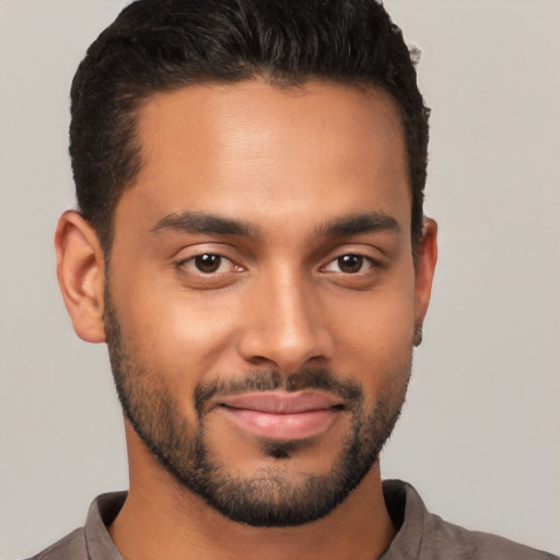 Joyful latino young-adult male with short  brown hair and brown eyes