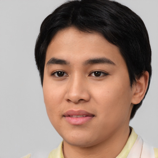 Joyful asian young-adult male with short  black hair and brown eyes