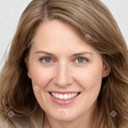 Joyful white adult female with long  brown hair and grey eyes