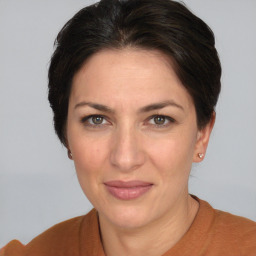 Joyful white adult female with short  brown hair and grey eyes