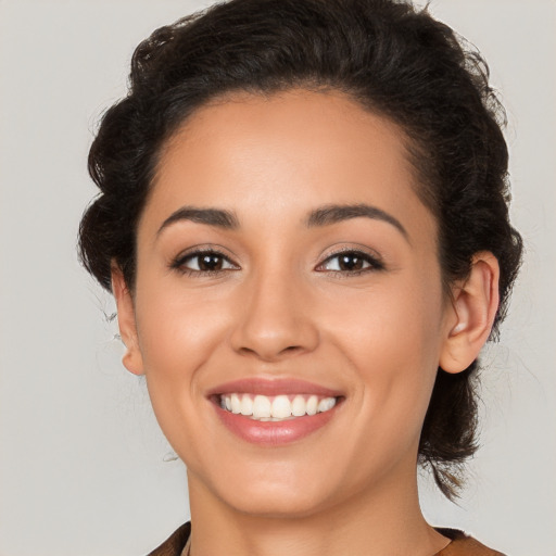 Joyful latino young-adult female with medium  brown hair and brown eyes