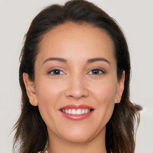 Joyful white young-adult female with long  brown hair and brown eyes