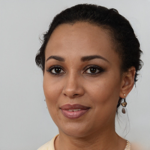 Joyful black young-adult female with medium  brown hair and brown eyes
