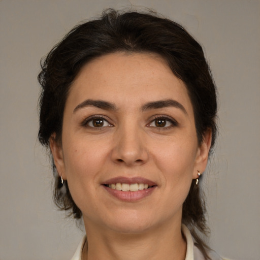 Joyful white young-adult female with medium  brown hair and brown eyes