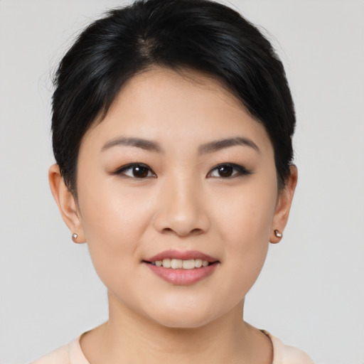 Joyful asian young-adult female with short  brown hair and brown eyes