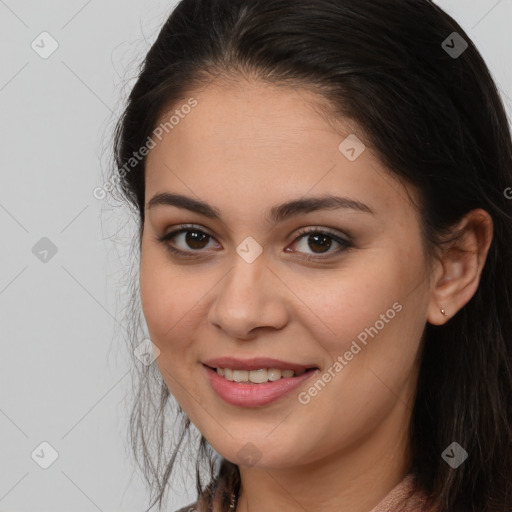 Joyful white young-adult female with long  brown hair and brown eyes