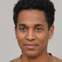 Joyful black young-adult male with short  black hair and brown eyes