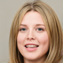 Joyful white young-adult female with long  brown hair and green eyes