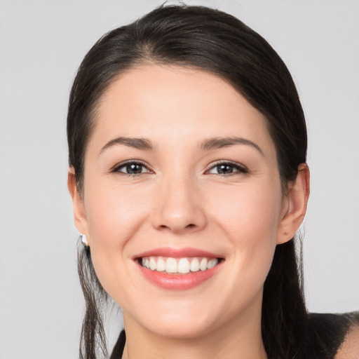 Joyful white young-adult female with long  brown hair and brown eyes