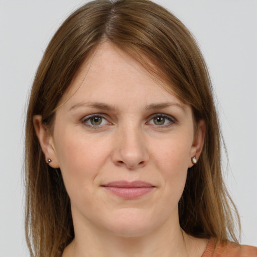 Joyful white young-adult female with long  brown hair and grey eyes