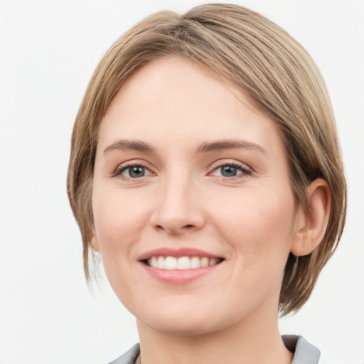 Joyful white young-adult female with medium  brown hair and grey eyes